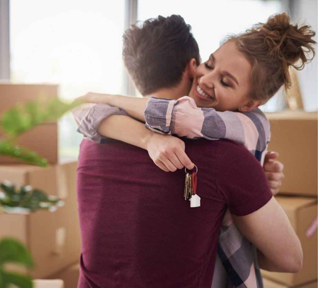 Couple Hugging New Home Keys